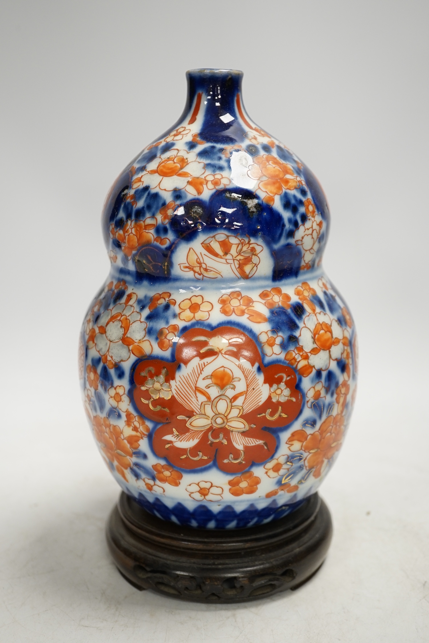 A Japanese Imari double gourd flask on stand, 23cm high. Condition - gilding worn otherwise good